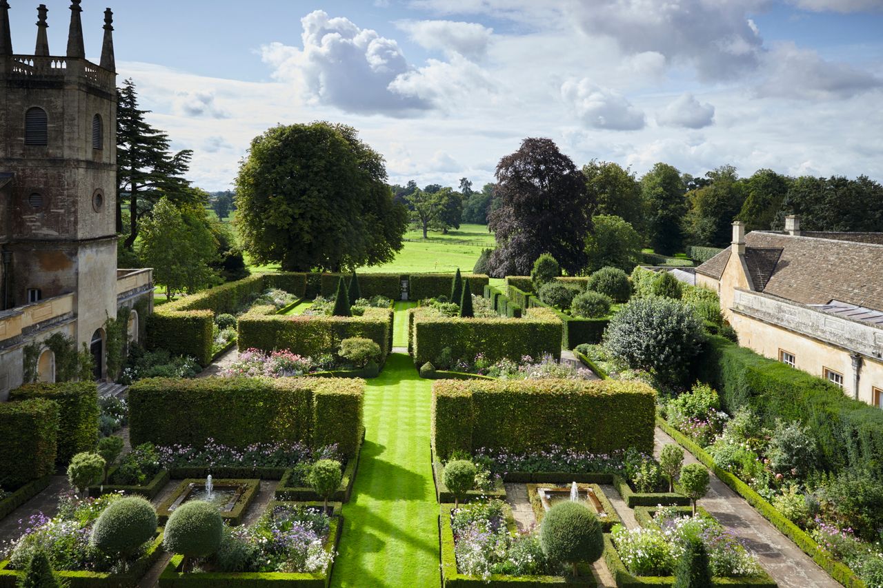 Tall hornbeam hedges enclose Goffinet&#039;s fine South Garden.