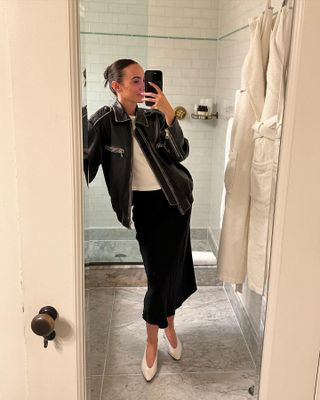 Liv Perez wearing a leather jacket, black skirt, and Loro Piana Rebecca flats