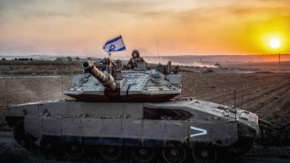 An Israeli soldier on a tank is seen near the Israel-Gaza border