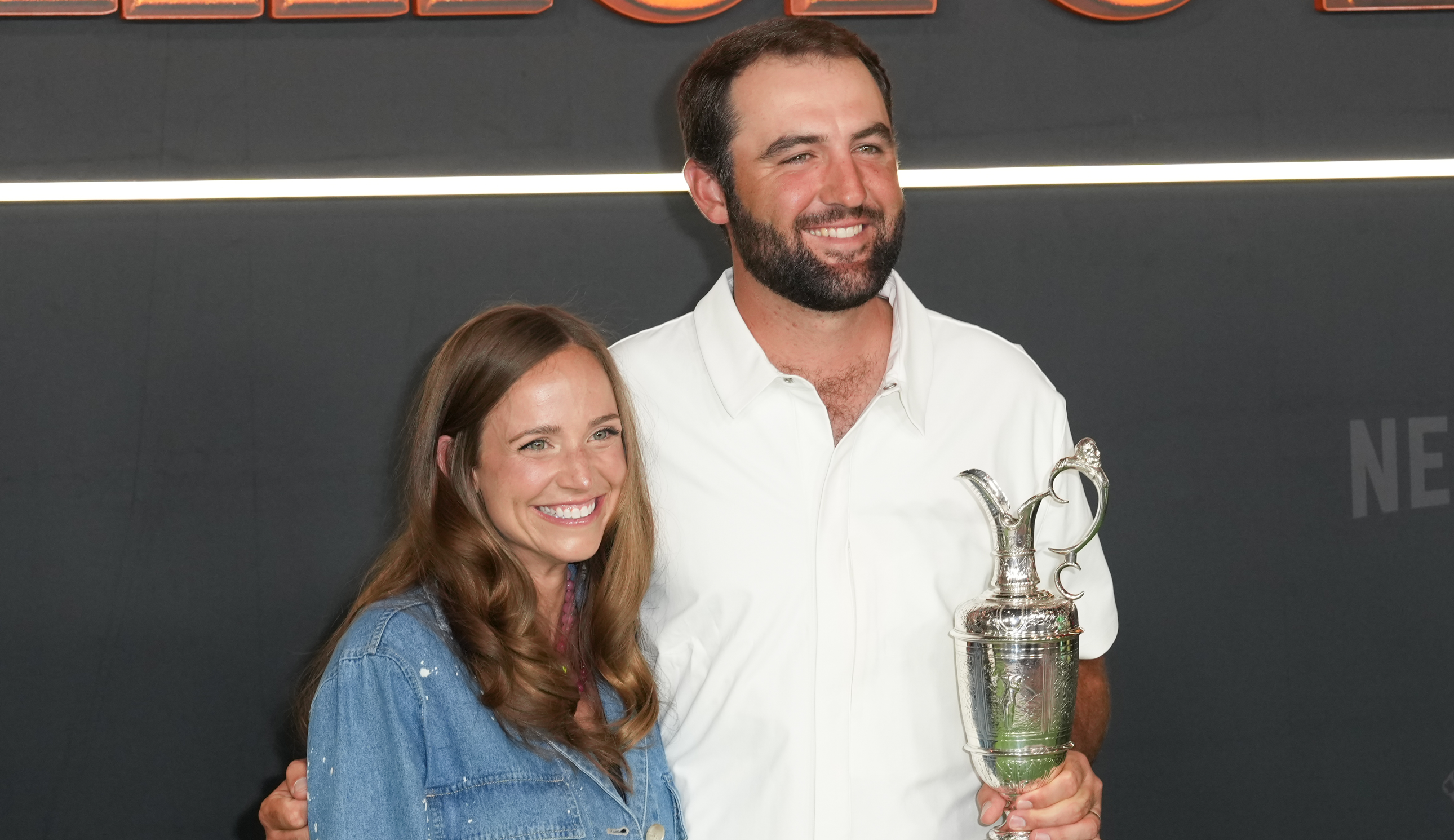 Scottie Scheffler with his wife and the Claret Jug