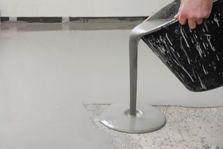 pouring liquid floor screed from a bucket