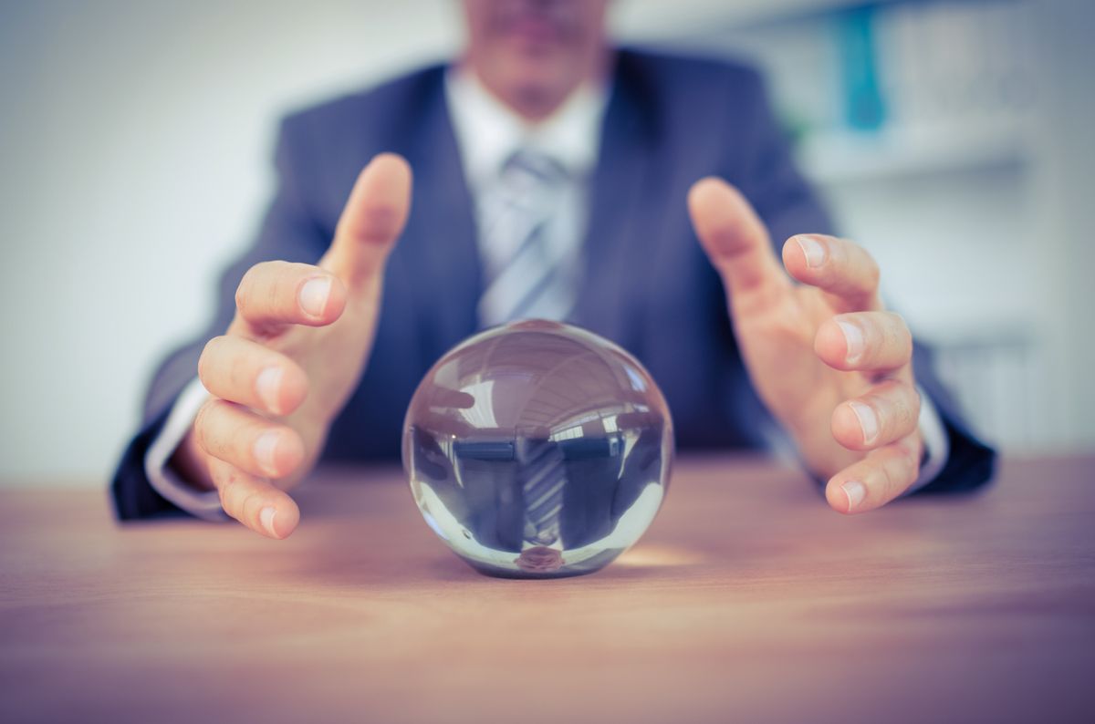 Man in suit taking hold of glass ball