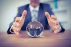 Man in suit taking hold of glass ball