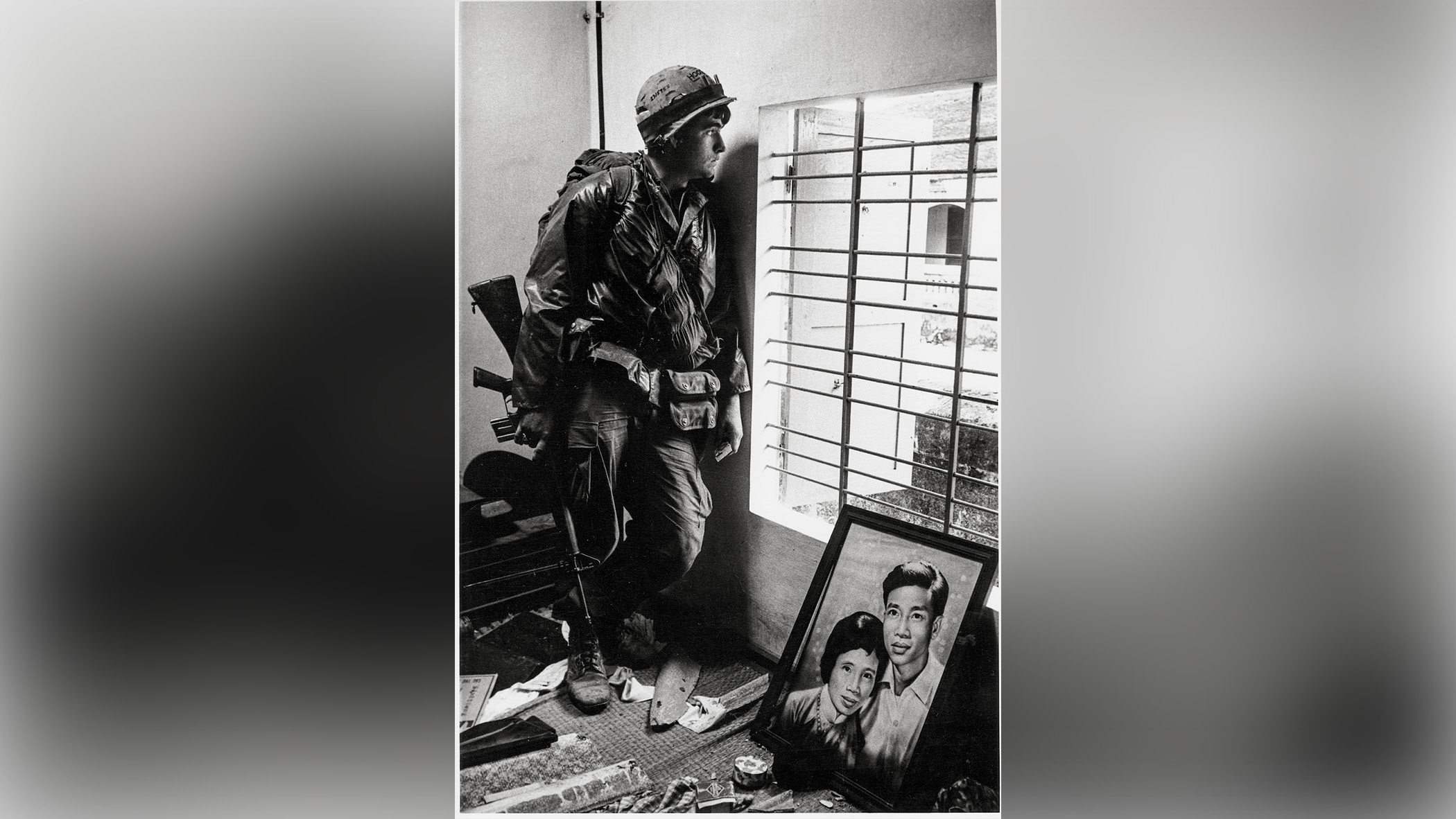 Soldier looks out of window.
