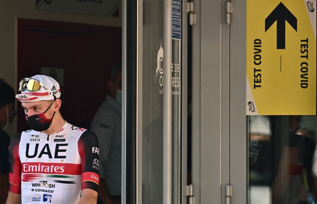 UAE Team Emirates teams Slovenian rider Tadej Pogacar L leaves the area after a mandatory Covid19 test after competing in the 15th stage of the 109th edition of the Tour de France cycling race 2025 km between Rodez and Carcassonne in southern France on July 17 2022 Photo by Marco BERTORELLO AFP Photo by MARCO BERTORELLOAFP via Getty Images