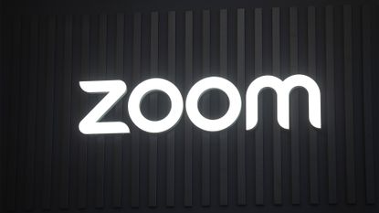 Zoom logo illuminated in white against a black background at the company's exhibitor stall at ISE 2025 in Barcelona, Spain.
