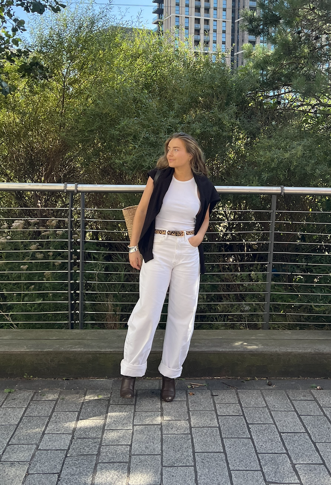 Lauren Cunningham wears white jeans, white tank top and leopard print belt