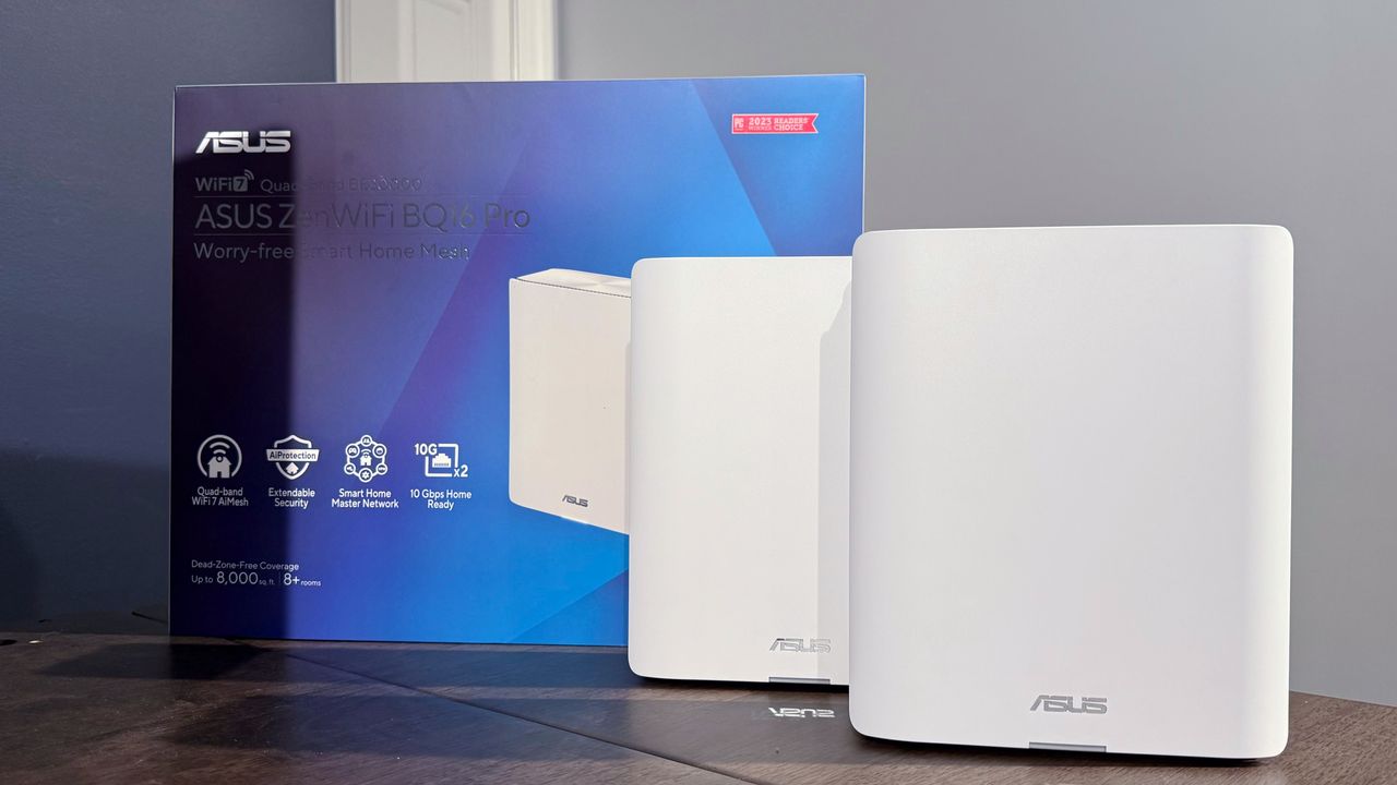 The white Asus ZenWifi BQ16 Pro next to its box on a table.