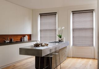 kitchen with contemporary scheme and standout concrete kitchen island by english blinds