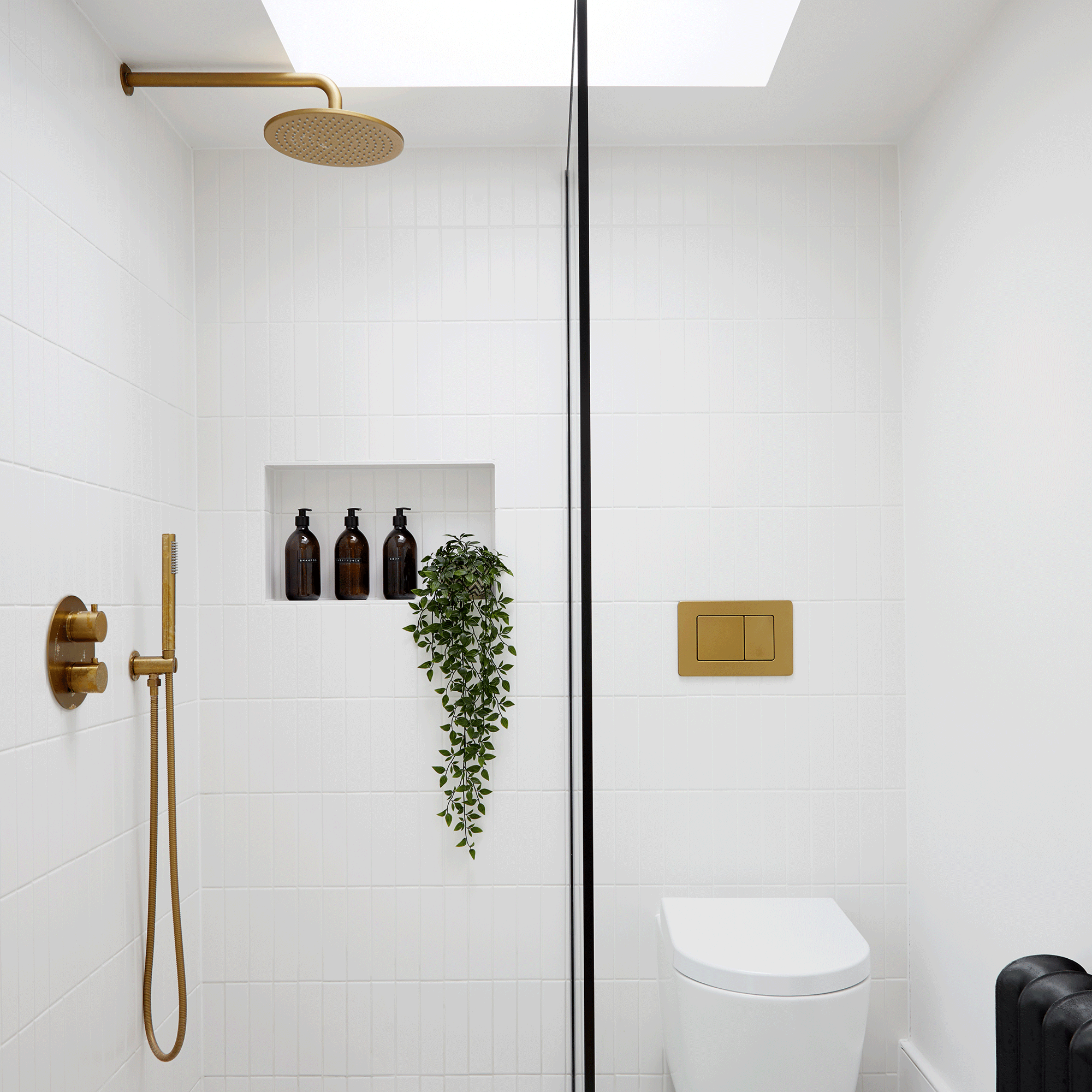 White shower room with gold shower head