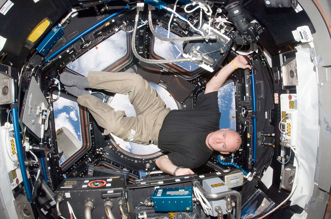 NASA astronaut Scott Kelly is pictured in the windowed cupola of the International Space Station in October 2010. He will return to the space station for a yearlong mission in March 2015.