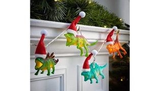 Dinosaurs wearing Santa hats, strung across a mantelpiece - one of this year's best Christmas lights from Asda.