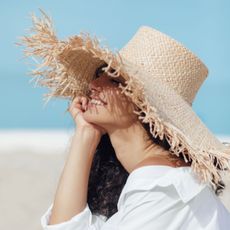 woman smiling in a sun hat