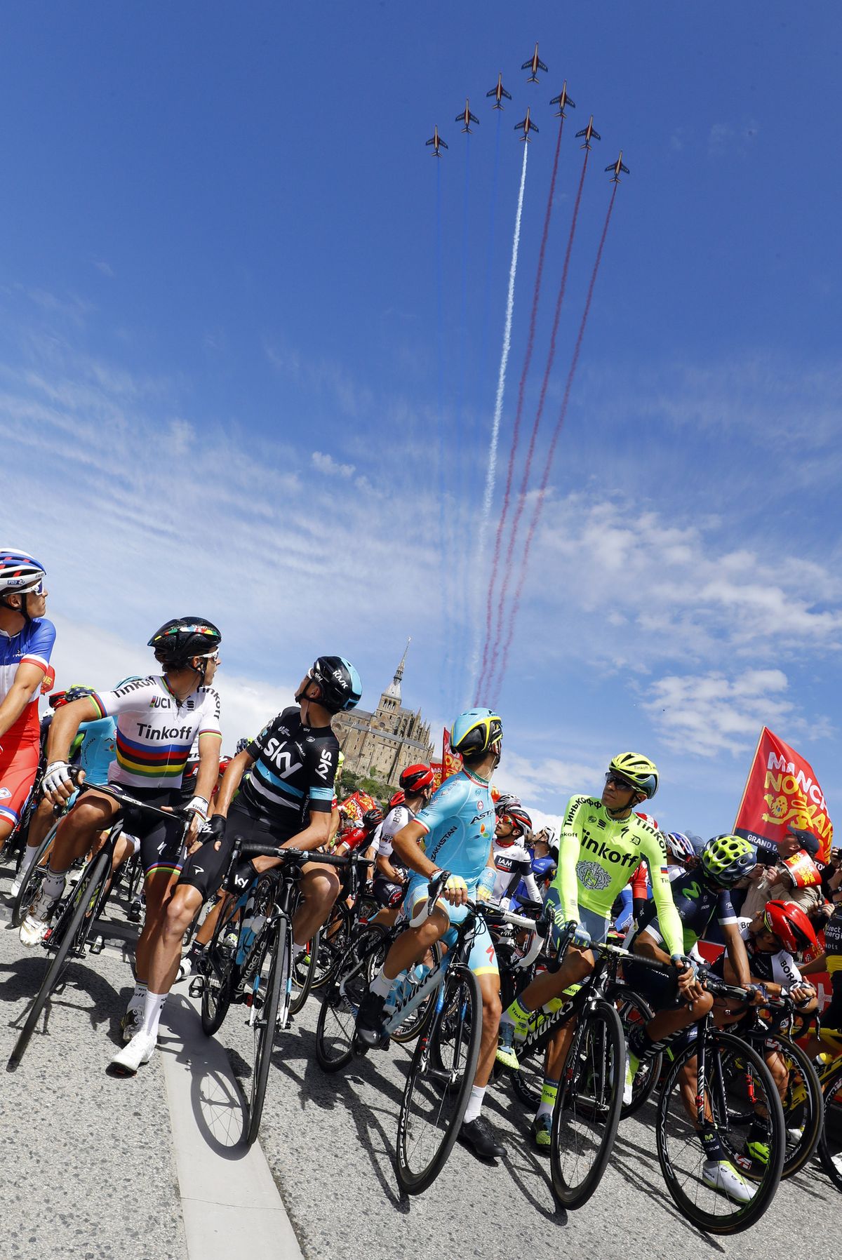 Riders watch the flyover on stage 1 of the Tour de France