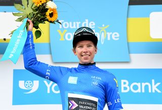 Lorena Wiebes of Team Parkhotel Valkenburg on the podium in the blue jersey after winning stage 1.