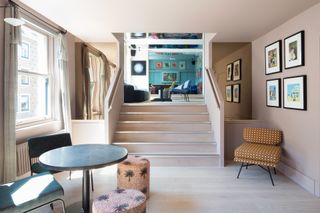 Natural timber steps leading up into a blue room at the Groucho Club in London