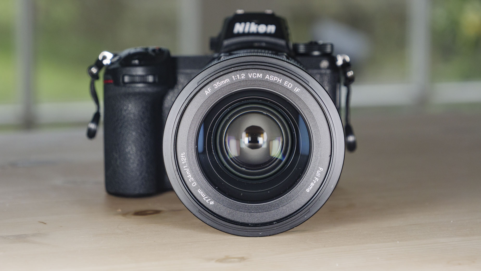 Viltrox AF 35mm F1.2 LAB Z lens for Nikon, attached to a Nikon Z6 II, on a wooden table