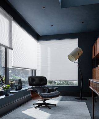 White honeycomb blinds in dark office by Blinds2Go