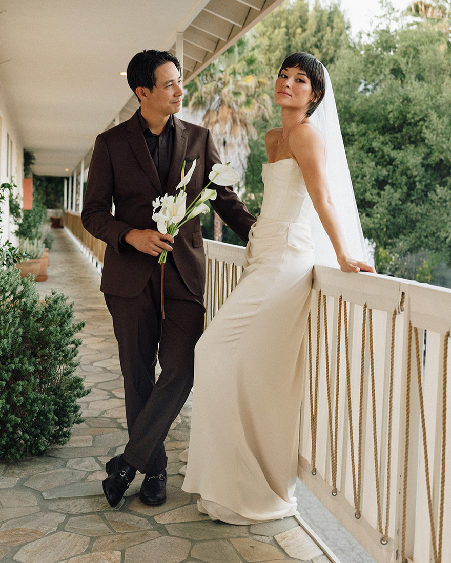 Britni and Sean wearing their wedding outfits.