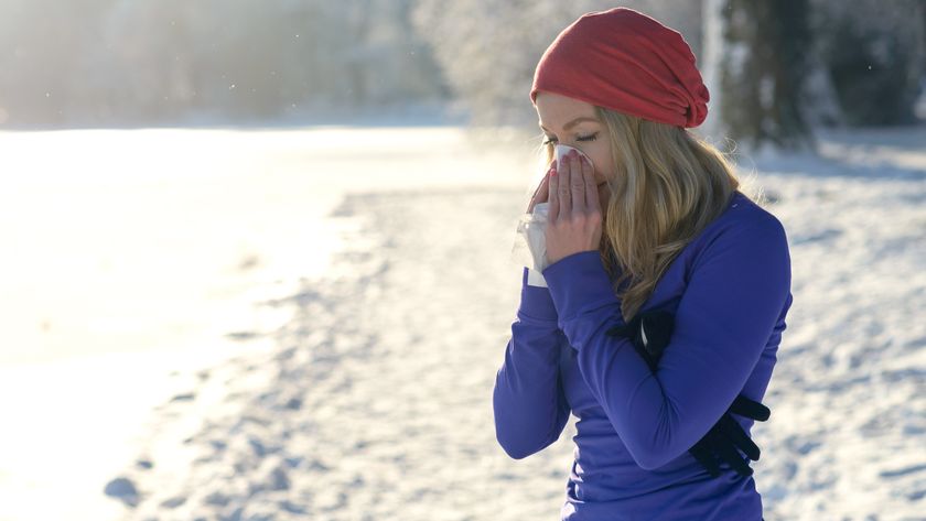 a woman on a run blowing her nose