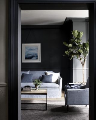 A grey living room idea by Neptune with grey-blue upholstered sofas, framed wall art and large houseplant