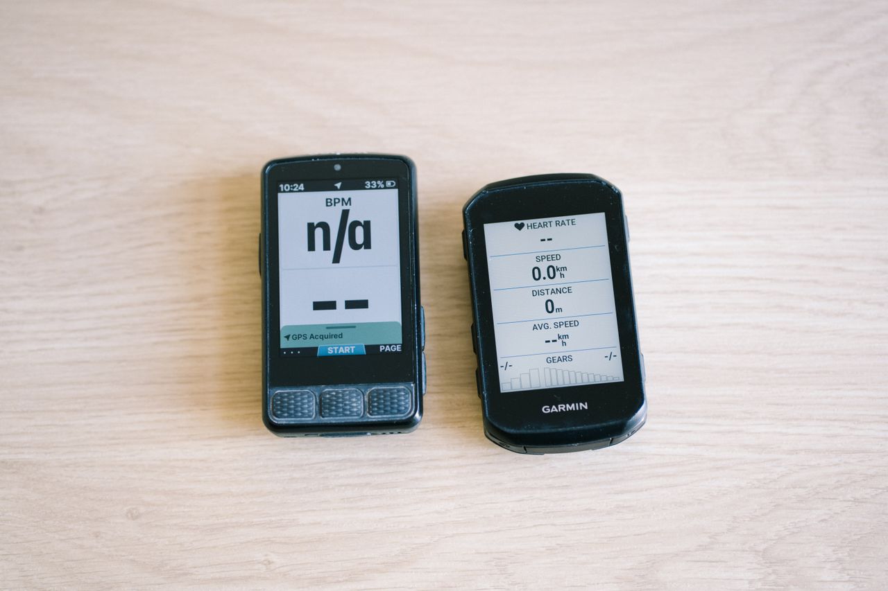 Bike computers on a table top showing different data screens