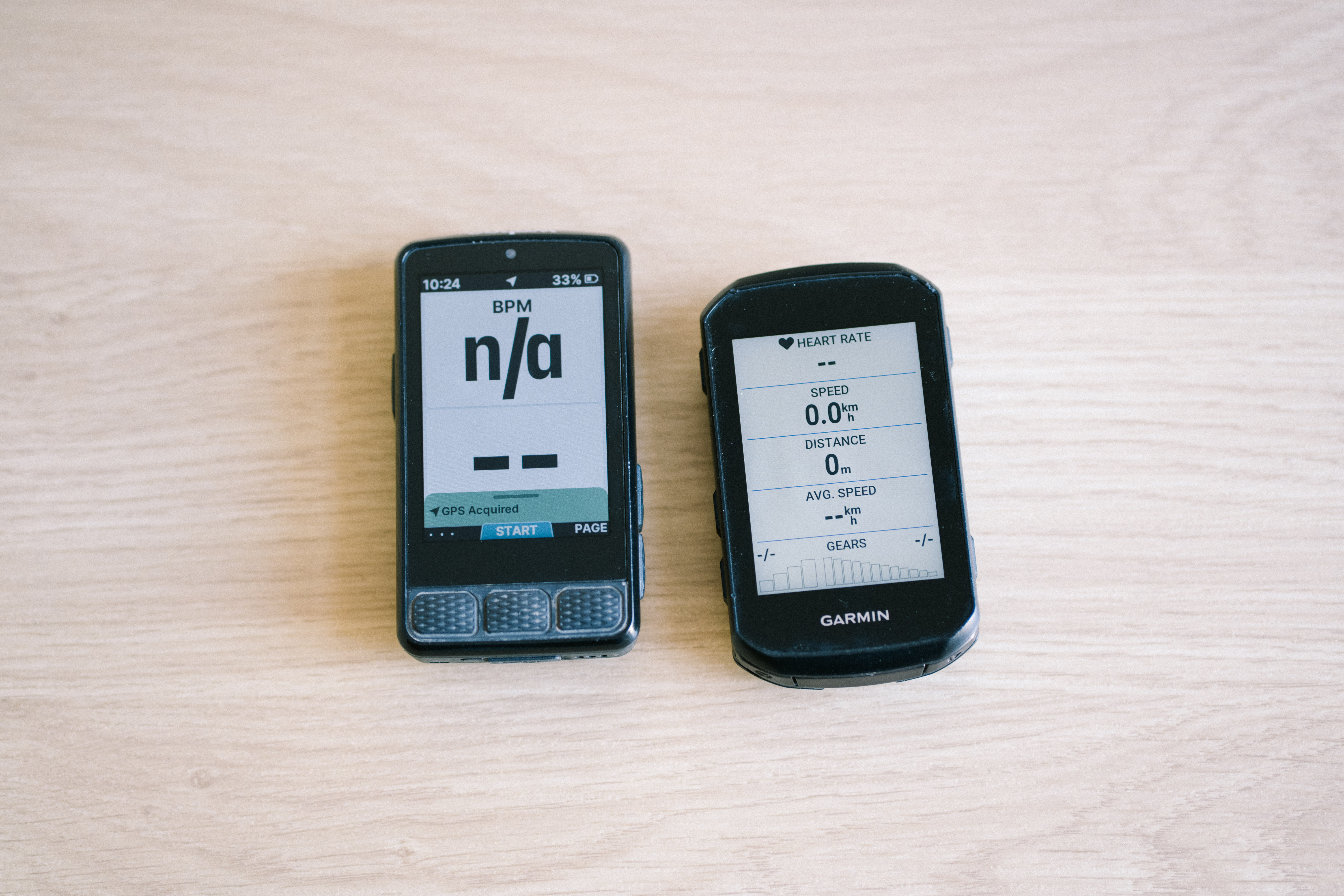 Bike computers on a table top showing different data screens