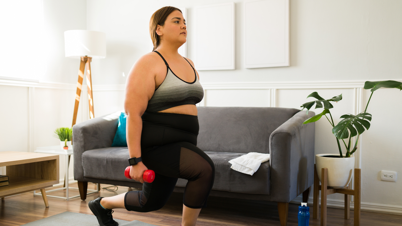 Woman doing a lunge with a pair of dumbbells