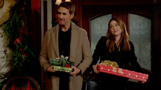 J. Eddie Peck and Hayley Erin as Cole and Claire carrying gifts in The Young and the Restless