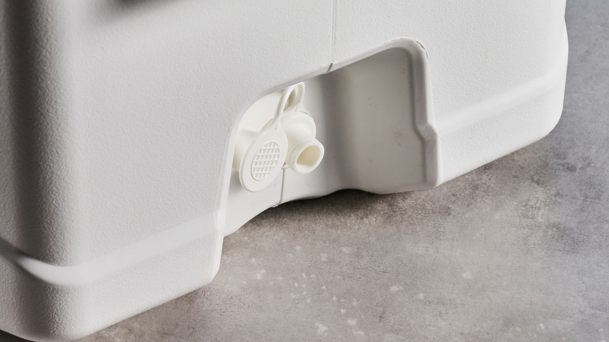 the igloo marine ultra 54 cooler in white with a latch, handles, a big igloo logo on the front and with a fish ruler and drink holders