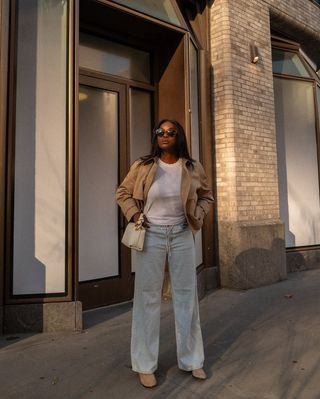 woman wearing light wash jeans and white t shirt