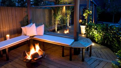 deck lighting ideas with bench and fire pit