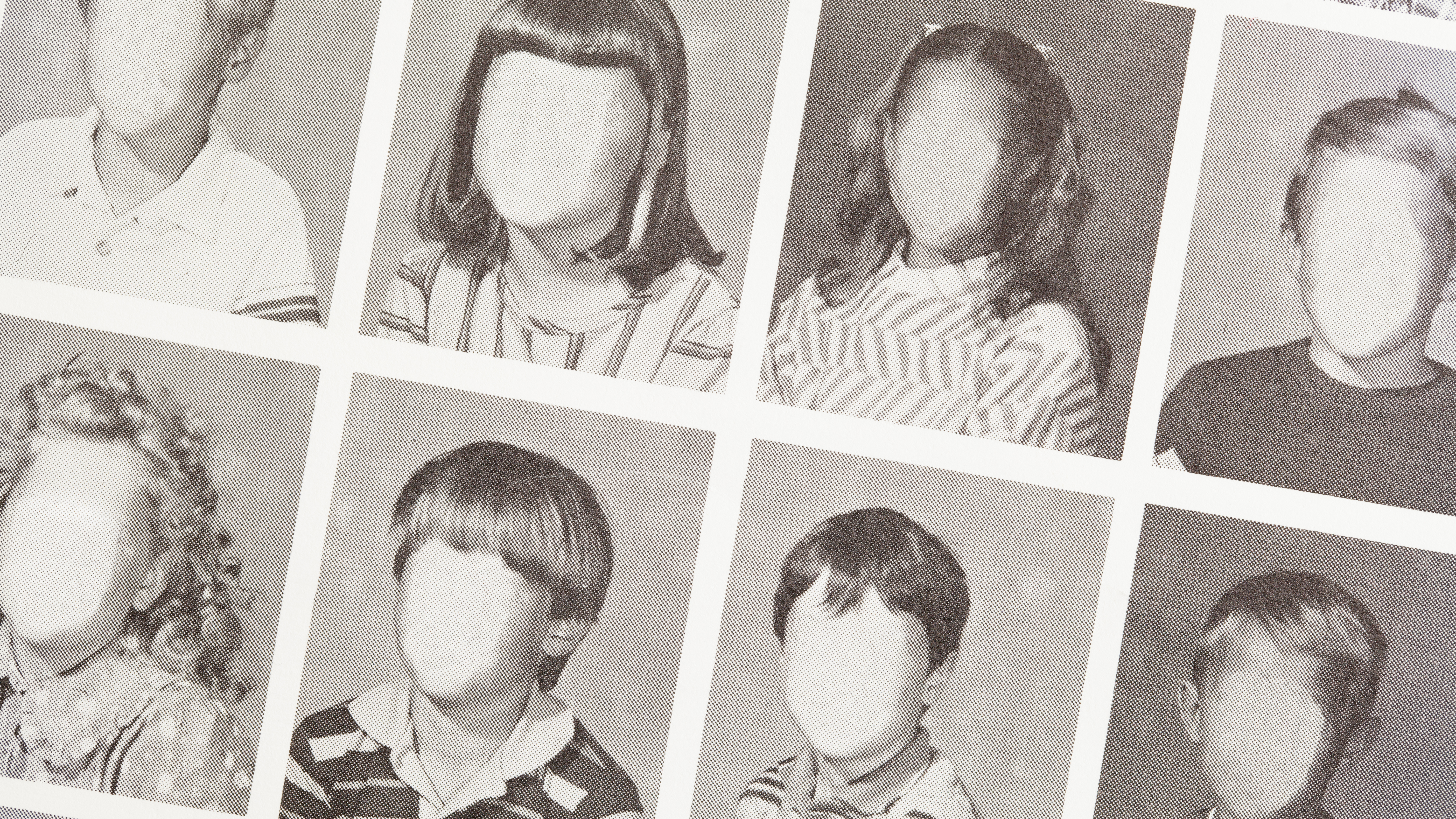 A line of black and white school photos with the faces blank