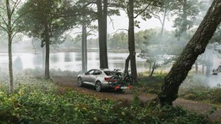 The Thule Epos bike rack carrying mountain bikes in forest