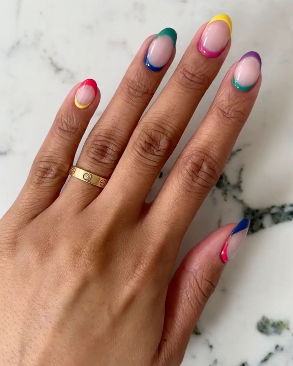 @iramshelton showcases a colourful nail art look with yellow, pink, blue and green polish