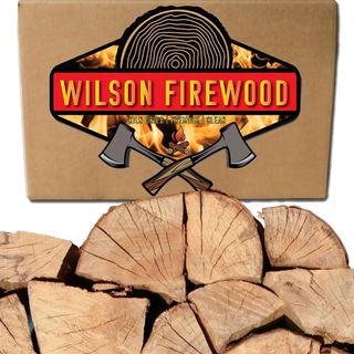 Chopped logs underneath a Wilson Firewood logo box showing two axes crossed over at the handle over a graphic of a tree slice and roaring fire