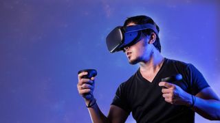 A shot of a man in a VR headset on a colourful blue background using the best VR apps