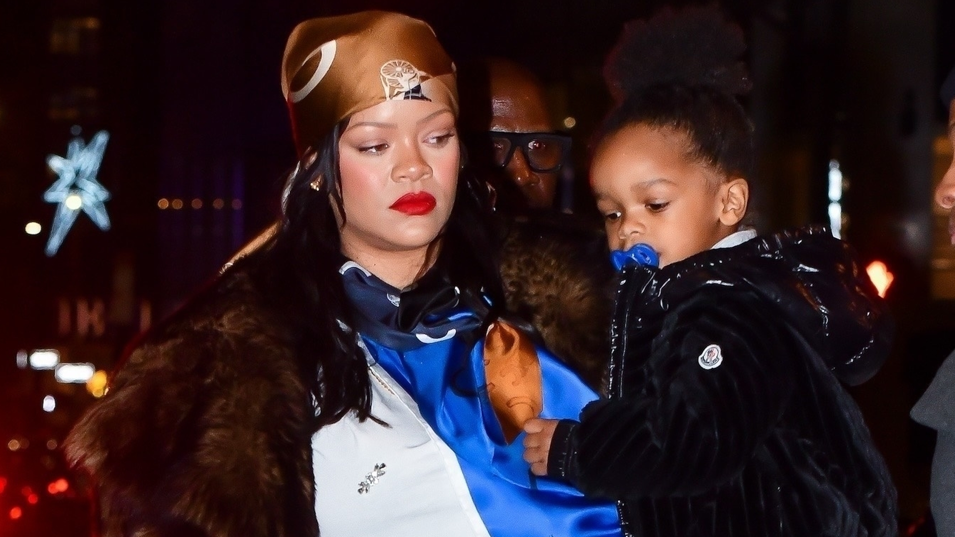 Rihanna was spotted in NYC wearing cargo pants, a fur coat, a silk head scarf, and the single-strap bag trend