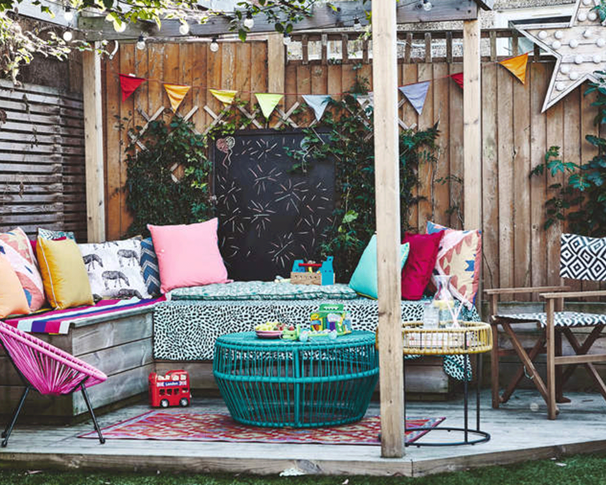 A kids activity center on a deck with chalkboard, bunting and colorful accessories