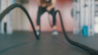 how to lose weight naturally: person using battle ropes