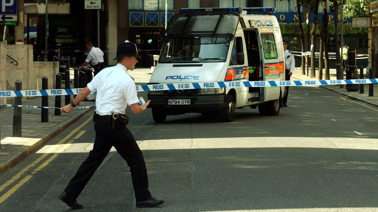 A police officer extends a cordon near Tavistock Square following the London 7/7 bombings