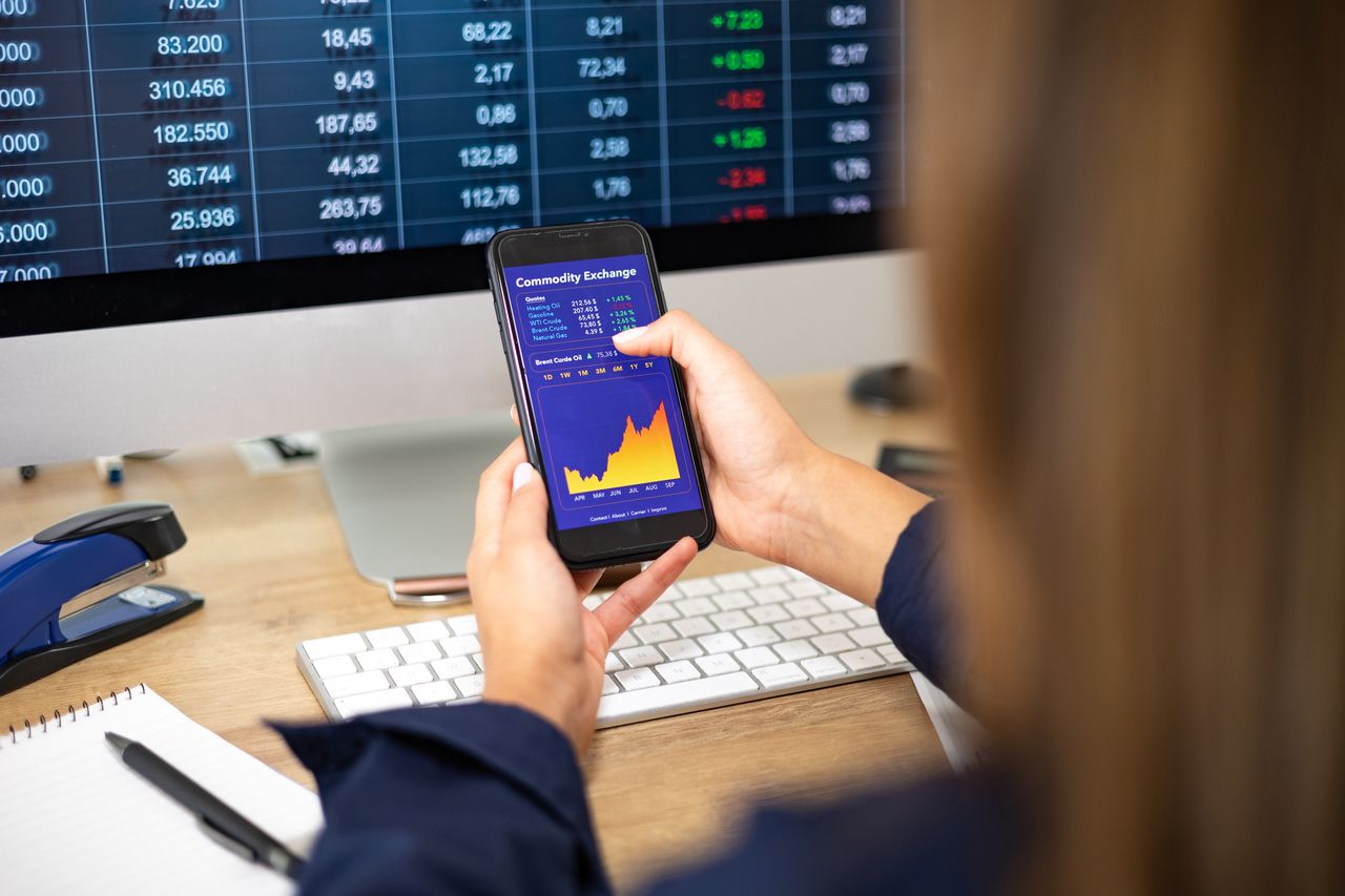 Woman watches oil and gas prices on her cell phone 