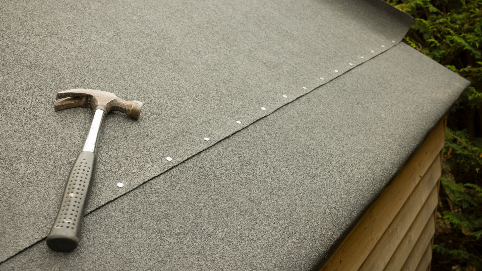 picture of shed roof with felting added and hammer on top