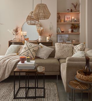 neutral living room with corner sofa and woven light pendants