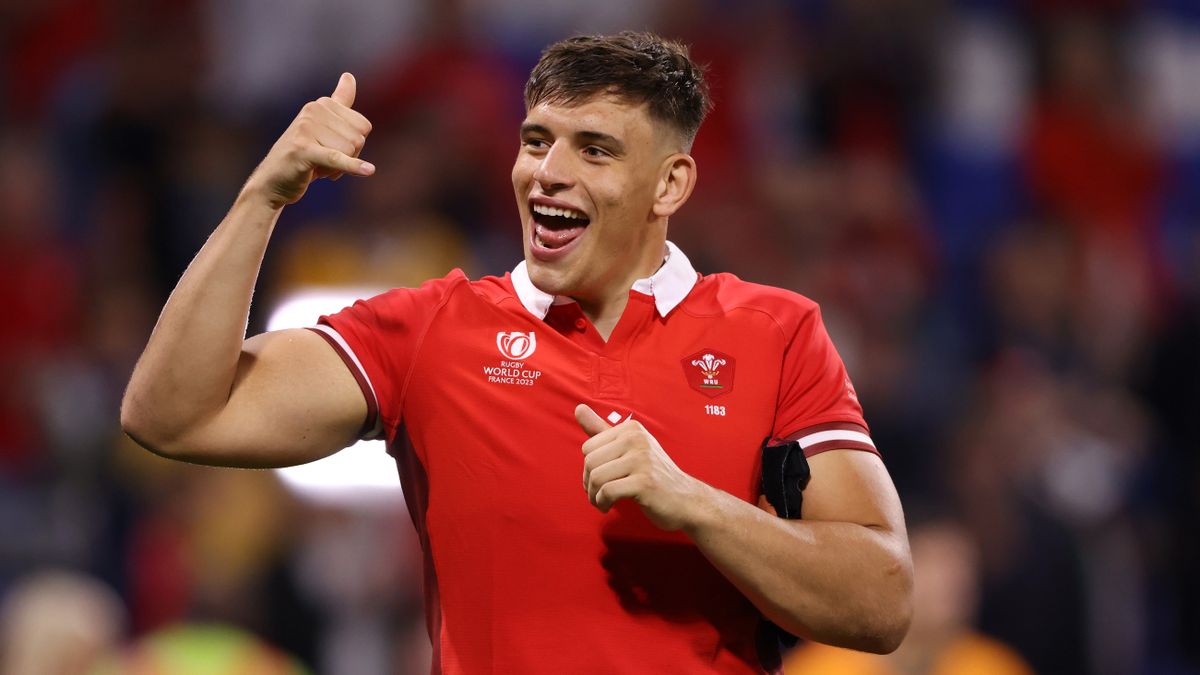 Wales Six Nations captain Dafydd Jenkins, wearing a red team shirt, celebrates ahead of the Wales vs Scotland clash.