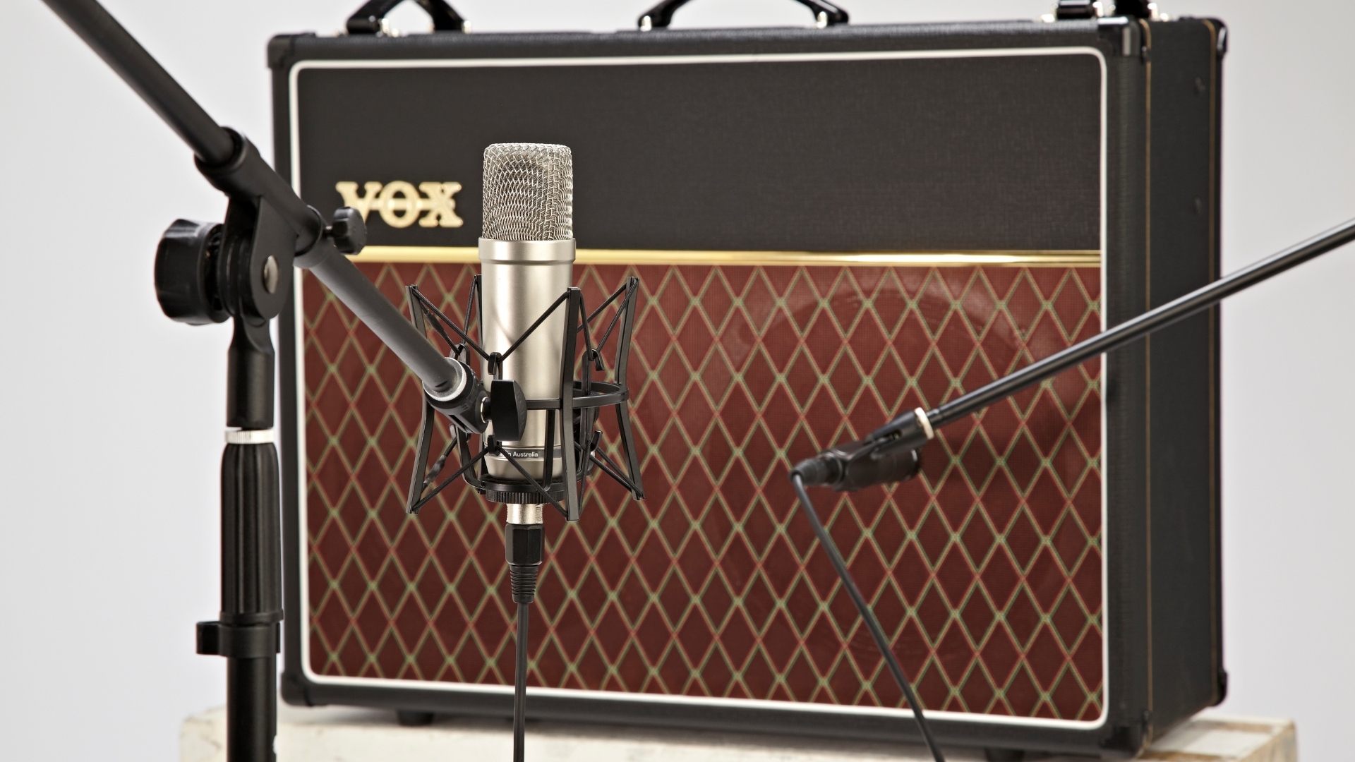 Two microphones in front of a Vox guitar amplifier