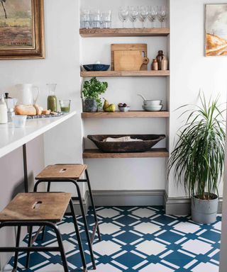 Dining area in small kitchen using checkered blue floor tiles