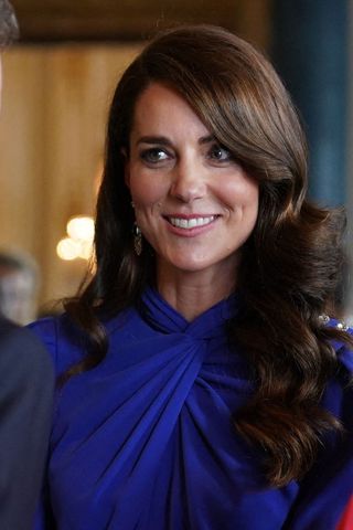 Kate Middleton headshot with a side parted curly hairstyle