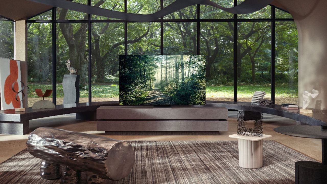 Samsung QN900A in larger room surround by floor-to-ceiling windows and modern art pieces