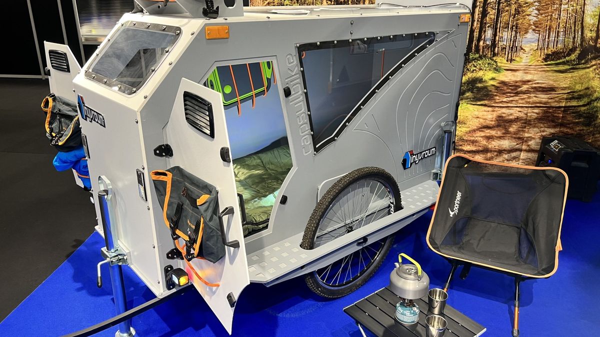 This tiny caravan for your e-bike includes a heated bedroom, kitchen, and even a bathroom